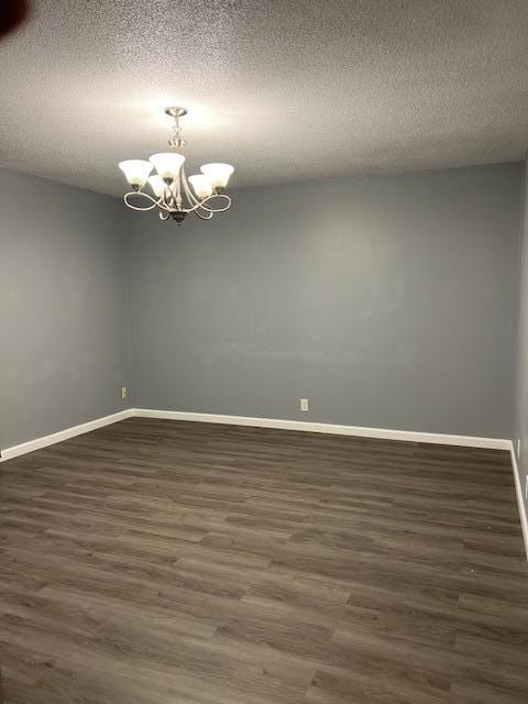 4918 Grenwich Trl N, Oakdale, MN 55128 - spare room with a chandelier, dark wood finished floors, and a textured ceiling