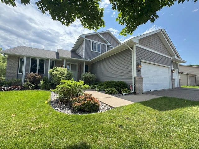 402 14th St, Delano, MN 55328 - view of front of property featuring a garage, a front lawn, brick siding, and driveway
