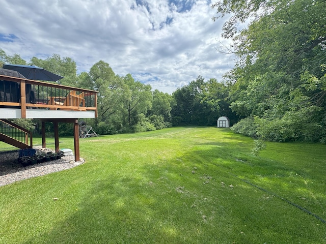 402 14th St, Delano, MN 55328 - view of green lawn featuring a shed, a wooden deck, and stairs