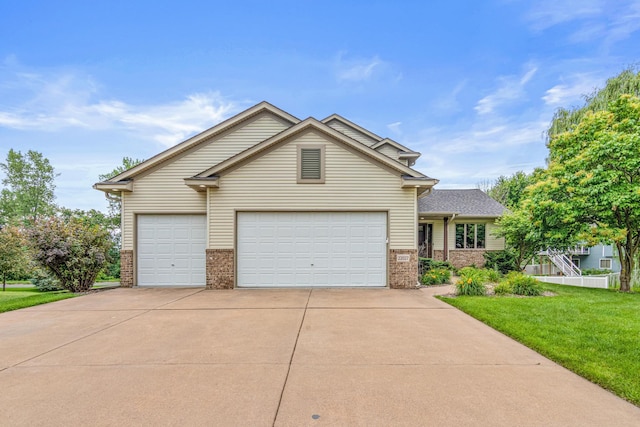 22027 Ethan Ave, Forest Lake, MN 55025 - view of front of house with brick siding, a front yard, concrete driveway, and an attached garage