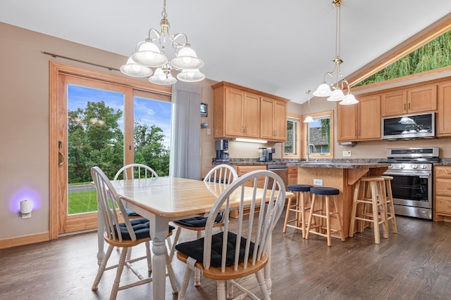 22027 Ethan Ave, Forest Lake, MN 55025 - dining space with a chandelier, vaulted ceiling, and dark wood-type flooring