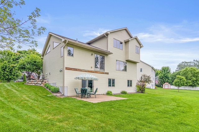 22027 Ethan Ave, Forest Lake, MN 55025 - rear view of property with a patio area, a lawn, and a storage shed