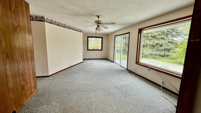 112 4th St E, Park Rapids, MN 56470 - spare room with light colored carpet, a ceiling fan, and a textured ceiling