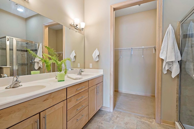 240 Spring St Unit 413, Saint Paul, MN 55102 - full bathroom with double vanity, a shower stall, and a spacious closet