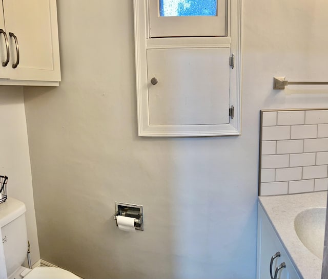 410 10th St SW, Willmar, MN 56201 - half bathroom featuring decorative backsplash and vanity