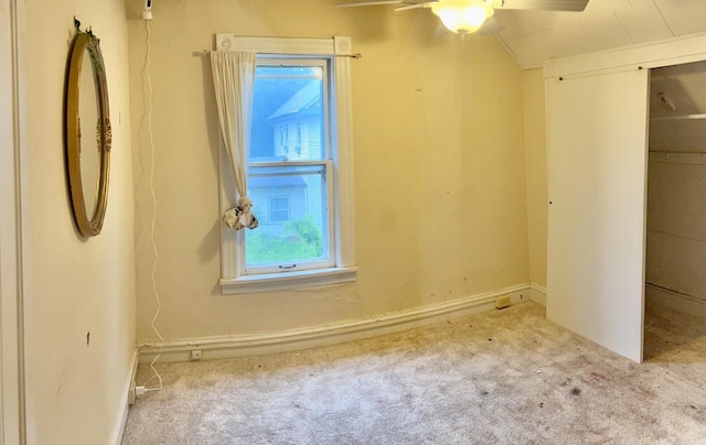 410 10th St SW, Willmar, MN 56201 - unfurnished bedroom featuring carpet flooring, vaulted ceiling, a closet, and ceiling fan