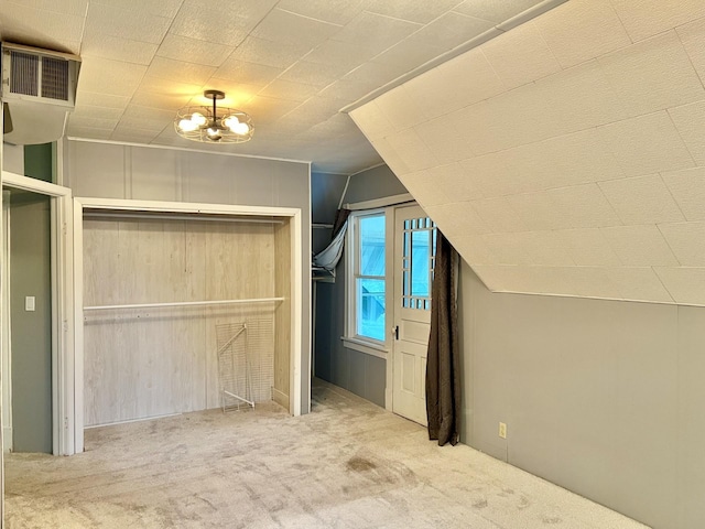 410 10th St SW, Willmar, MN 56201 - unfurnished bedroom featuring carpet, lofted ceiling, a closet, and a chandelier