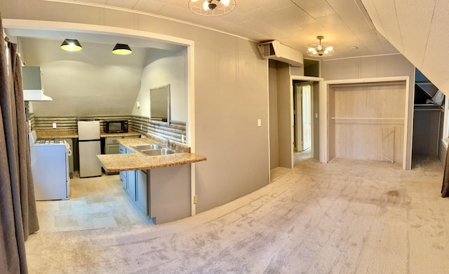 410 10th St SW, Willmar, MN 56201 - kitchen with black microwave, freestanding refrigerator, washer / clothes dryer, blue cabinetry, and white gas stove