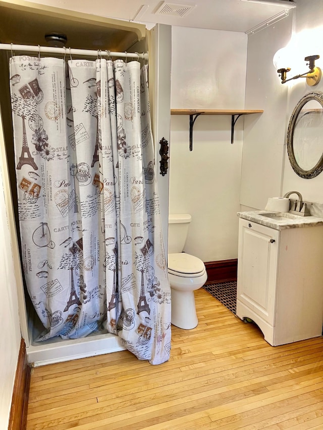 410 10th St SW, Willmar, MN 56201 - full bath with hardwood / wood-style flooring, vanity, and a shower with curtain