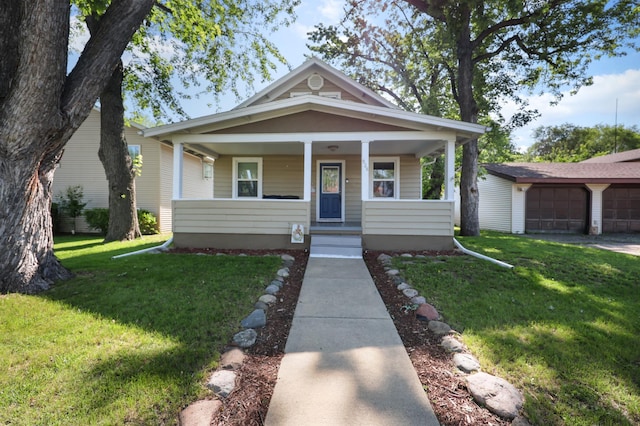 938 38th Ave N, Saint Cloud, MN 56303 - view of front of property featuring a front yard, a porch, and a detached garage