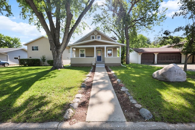 938 38th Ave N, Saint Cloud, MN 56303 - view of front of home with a front lawn, a porch, and a detached garage