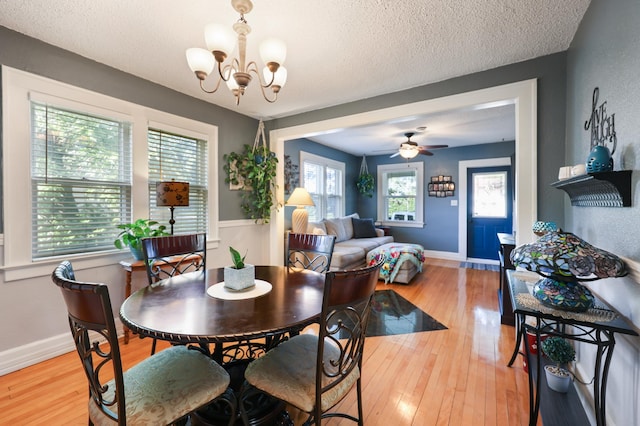 938 38th Ave N, Saint Cloud, MN 56303 - dining room featuring a chandelier, wood finished floors, a textured ceiling, and a ceiling fan