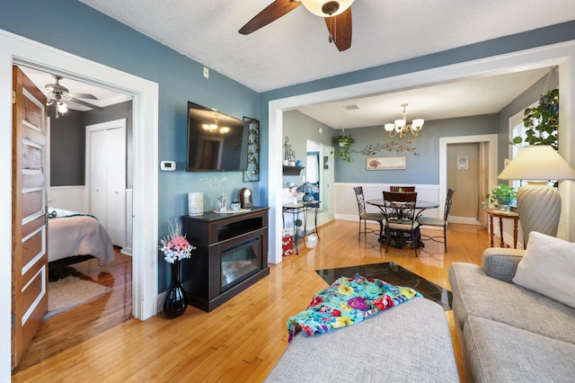 938 38th Ave N, Saint Cloud, MN 56303 - living room featuring a ceiling fan, hardwood / wood-style floors, and a chandelier