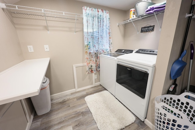 938 38th Ave N, Saint Cloud, MN 56303 - laundry area with washing machine and dryer and light wood-style floors
