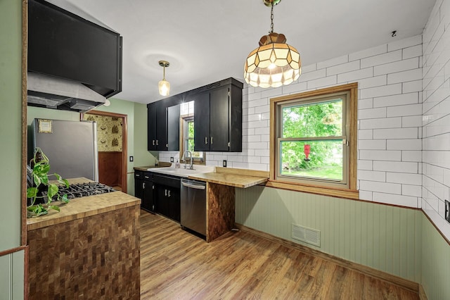 6121 Trinity Dr NE, Fridley, MN 55432 - kitchen with stainless steel appliances, wood counters, light wood-style flooring, and dark cabinetry