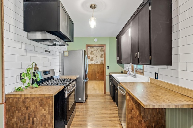 6121 Trinity Dr NE, Fridley, MN 55432 - kitchen with stainless steel appliances, range hood, light wood-type flooring, wood counters, and decorative backsplash