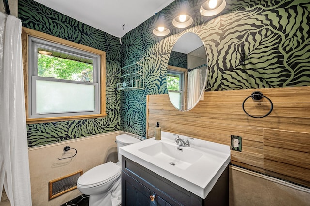 6121 Trinity Dr NE, Fridley, MN 55432 - bathroom with wallpapered walls, vanity, wainscoting, healthy amount of natural light, and curtained shower
