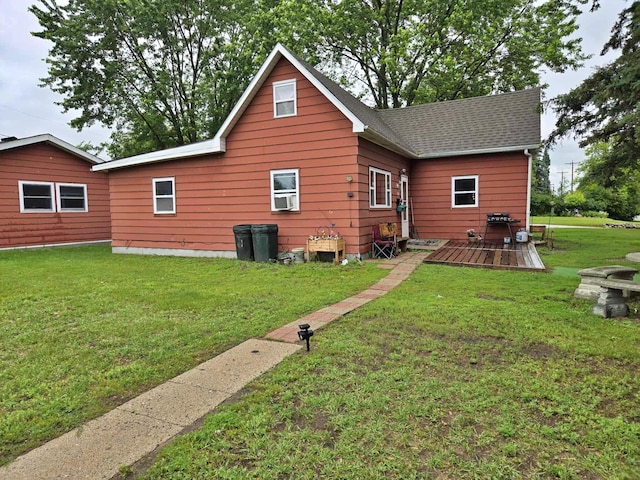 607 Riverside Ave, Park Rapids, MN 56470 - back of property with a yard, a wooden deck, and a shingled roof