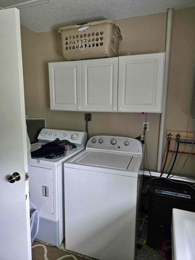 607 Riverside Ave, Park Rapids, MN 56470 - washroom featuring washing machine and dryer, cabinet space, and a textured ceiling