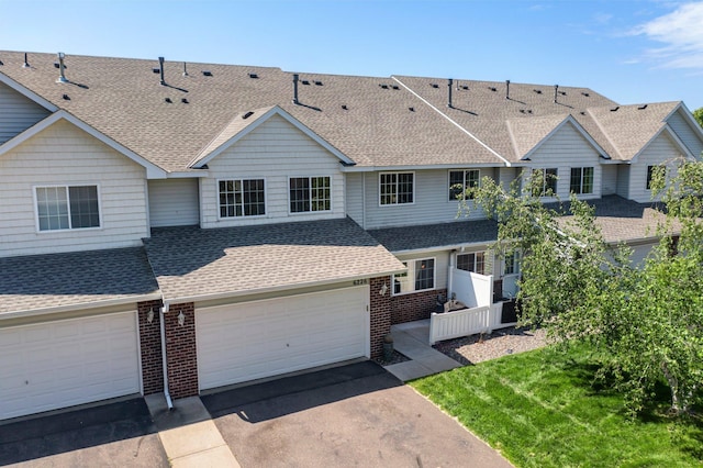 6226 Maclynn Ave NE, Otsego, MN 55301 - multi unit property featuring a shingled roof, driveway, brick siding, and an attached garage