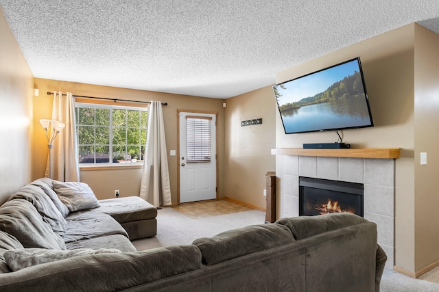 6226 Maclynn Ave NE, Otsego, MN 55301 - living area featuring light colored carpet, a tiled fireplace, and a textured ceiling