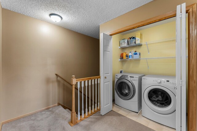 6226 Maclynn Ave NE, Otsego, MN 55301 - laundry area featuring washer and clothes dryer, a textured ceiling, and light carpet