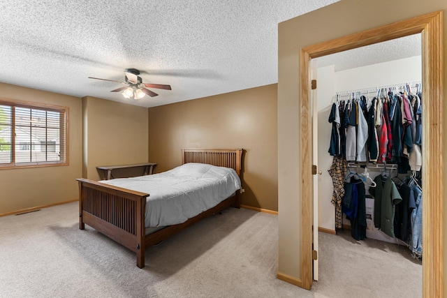 6226 Maclynn Ave NE, Otsego, MN 55301 - bedroom featuring a spacious closet, light carpet, a closet, a textured ceiling, and ceiling fan