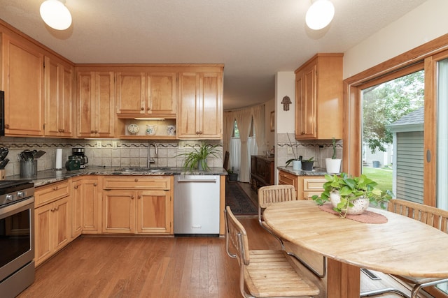1163 Edgcumbe Rd Unit 1163, Saint Paul, MN 55105 - kitchen with appliances with stainless steel finishes, decorative backsplash, wood finished floors, dark stone counters, and open shelves