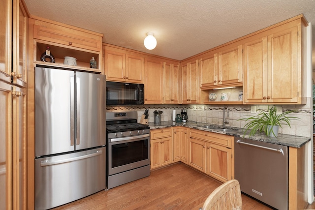 1163 Edgcumbe Rd Unit 1163, Saint Paul, MN 55105 - kitchen with stainless steel appliances, open shelves, light wood-style flooring, decorative backsplash, and dark stone countertops