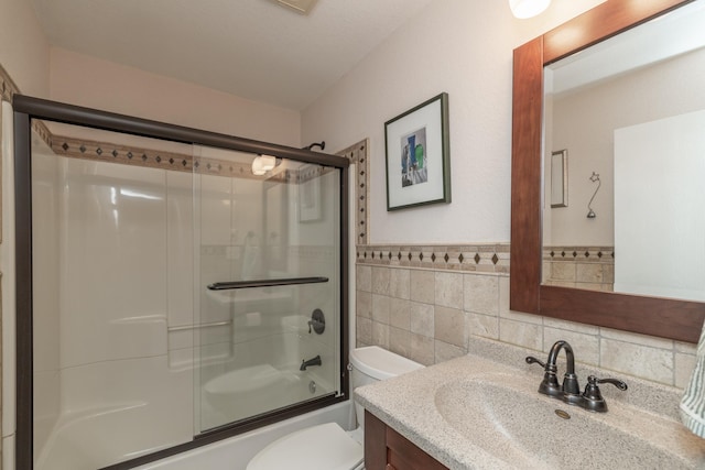 1163 Edgcumbe Rd Unit 1163, Saint Paul, MN 55105 - bathroom with tile walls, vanity, enclosed tub / shower combo, and a wainscoted wall