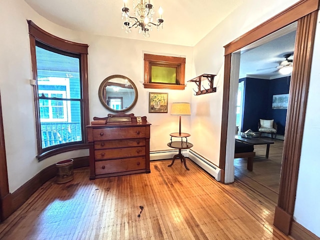 3128 Portland Ave, Minneapolis, MN 55407 - corridor featuring baseboard heating, wood-type flooring, and healthy amount of natural light