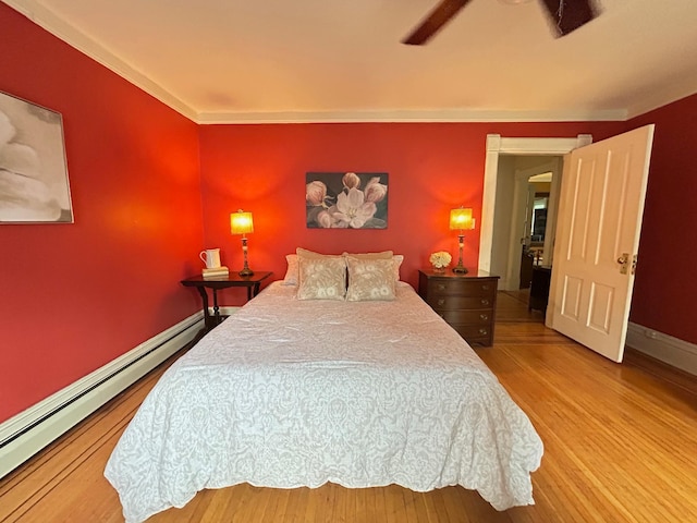 3128 Portland Ave, Minneapolis, MN 55407 - bedroom with a baseboard heating unit, wood finished floors, and crown molding