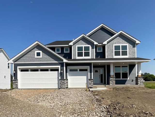 5890 Rathbun Ave NE, Otsego, MN 55374 - craftsman-style home with stone siding, covered porch, driveway, and a garage