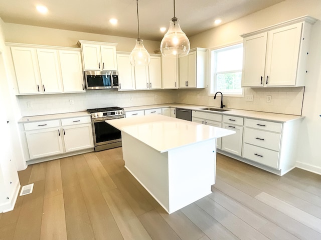 5890 Rathbun Ave NE, Otsego, MN 55374 - kitchen with appliances with stainless steel finishes, white cabinetry, light countertops, tasteful backsplash, and recessed lighting