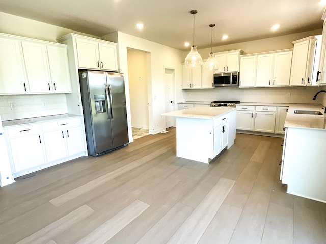 5890 Rathbun Ave NE, Otsego, MN 55374 - kitchen featuring appliances with stainless steel finishes, recessed lighting, a center island, backsplash, and white cabinetry
