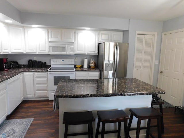 2524 25th Ave S, Fargo, ND 58103 - kitchen featuring white appliances, a kitchen breakfast bar, white cabinets, dark wood-style floors, and recessed lighting