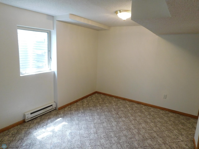 2524 25th Ave S, Fargo, ND 58103 - basement with a baseboard heating unit, carpet, and a textured ceiling