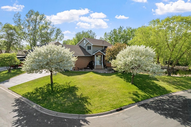 5390 157th St N, Hugo, MN 55038 - view of property hidden behind natural elements featuring a front lawn and brick siding