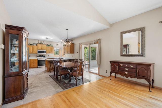 5390 157th St N, Hugo, MN 55038 - dining area featuring a chandelier, light wood-style floors, and lofted ceiling