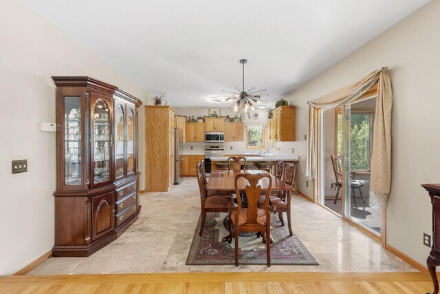 5390 157th St N, Hugo, MN 55038 - dining area featuring a chandelier and baseboards