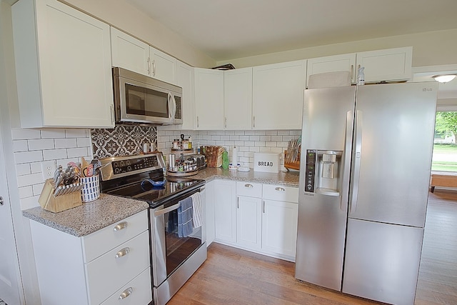 1016 26th Ave N, Saint Cloud, MN 56303 - kitchen with stainless steel appliances, light wood-style floors, white cabinetry, and light stone counters