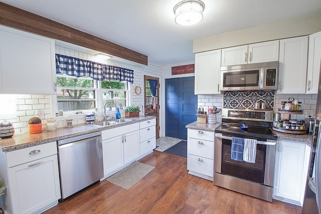 1016 26th Ave N, Saint Cloud, MN 56303 - kitchen with stainless steel appliances, decorative backsplash, white cabinets, and light stone counters