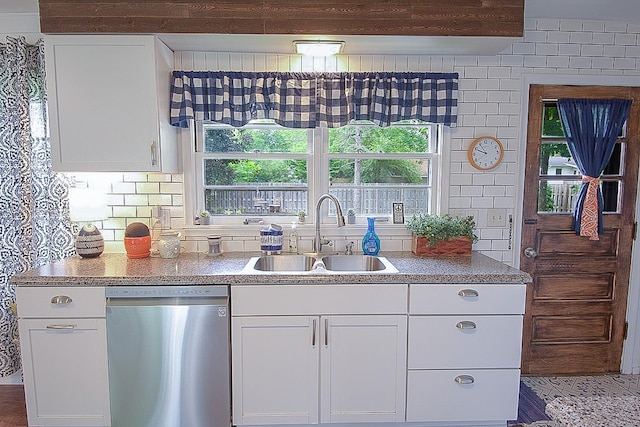 1016 26th Ave N, Saint Cloud, MN 56303 - kitchen with stainless steel dishwasher, tasteful backsplash, and white cabinets