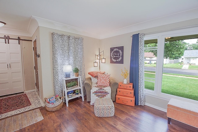 1016 26th Ave N, Saint Cloud, MN 56303 - living area featuring a barn door, wood finished floors, and ornamental molding