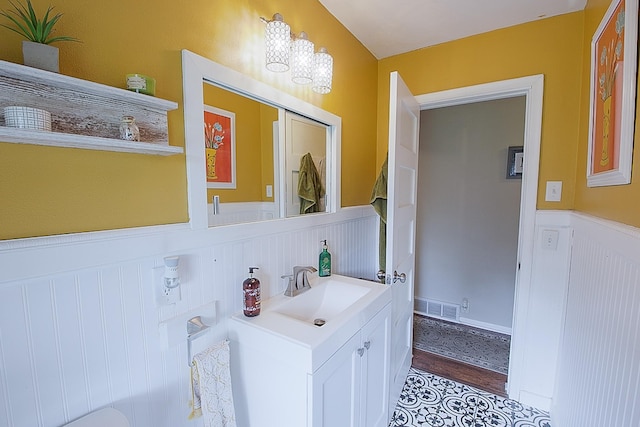 1016 26th Ave N, Saint Cloud, MN 56303 - bathroom featuring a wainscoted wall, vanity, and wood finished floors