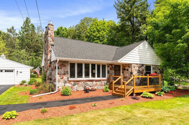 2821 Harvey St, Duluth, MN 55811 - view of front of home featuring stone siding, a shingled roof, a wooden deck, a chimney, and a garage