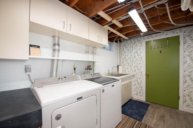 1704 Fair St, Mankato, MN 56001 - laundry area featuring washing machine and dryer, cabinet space, light wood-type flooring, and wallpapered walls