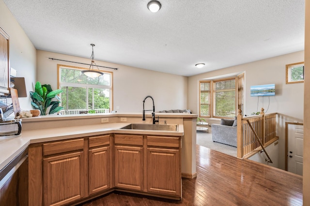 20060 Heritage Dr, Lakeville, MN 55044 - kitchen with open floor plan, a textured ceiling, healthy amount of natural light, dark wood-type flooring, and pendant lighting