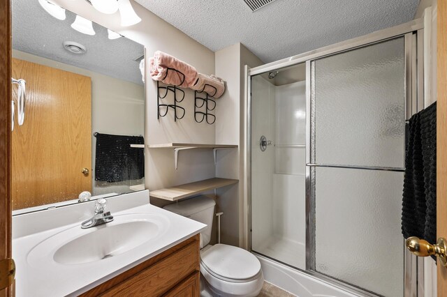 20060 Heritage Dr, Lakeville, MN 55044 - bathroom featuring a shower stall, vanity, and a textured ceiling