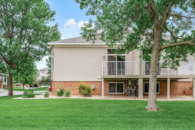 20060 Heritage Dr, Lakeville, MN 55044 - back of house featuring brick siding, a lawn, and a wooden deck